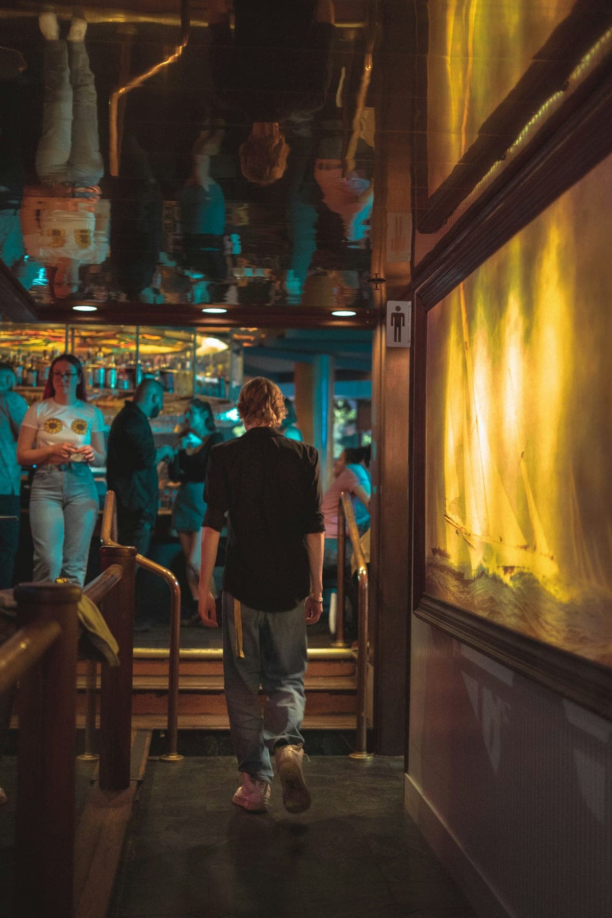 A small group of friends arriving together at a warm, softly lit venue